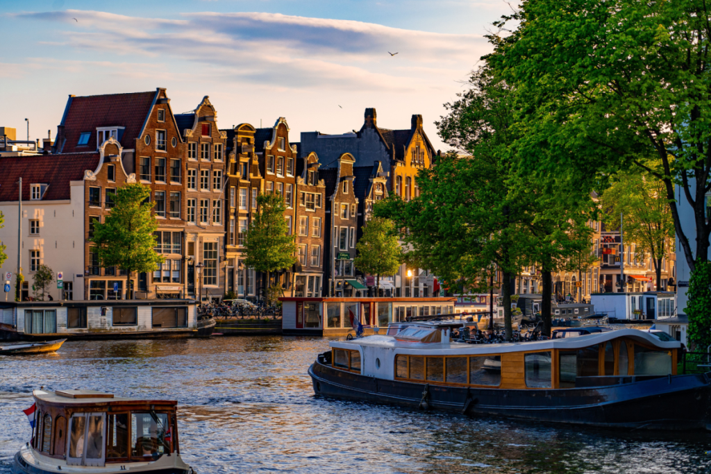 Klassische Grachtenhäuser und Rundfahrtboote am historischen Grachtengürtel von Amsterdam