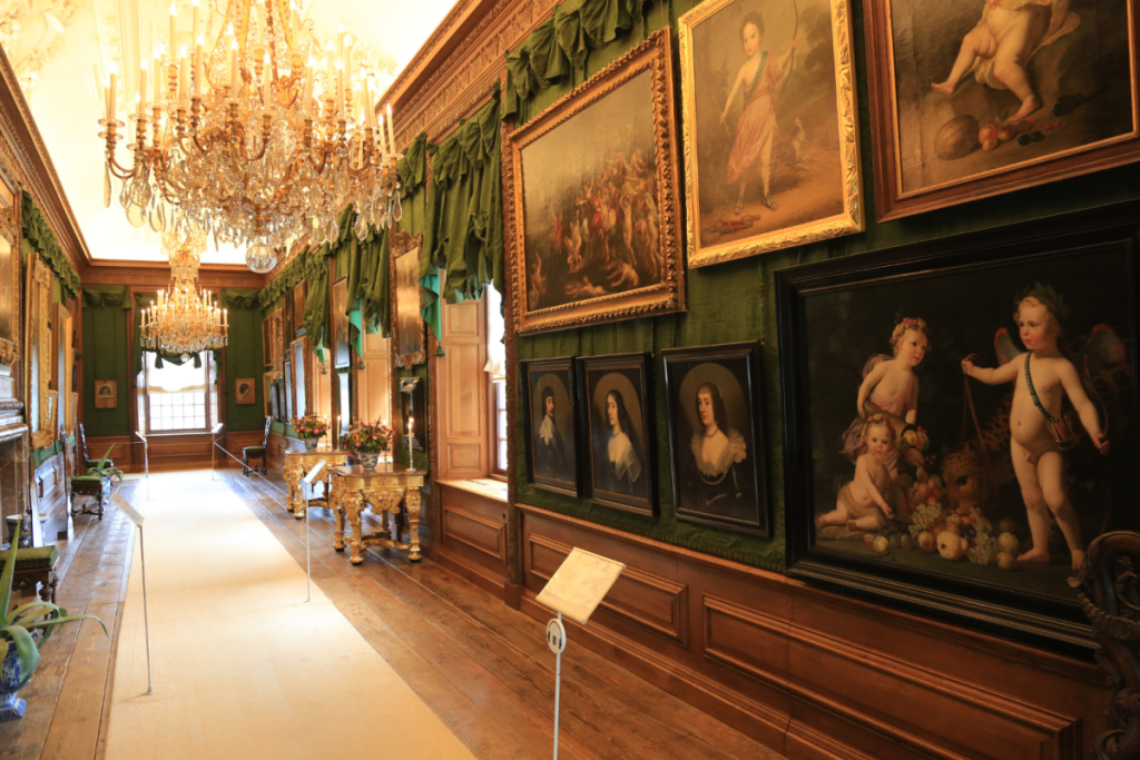 Gemäldegalerie mit goldenen Kronleuchtern und klassischen Porträts im Palast Het Loo