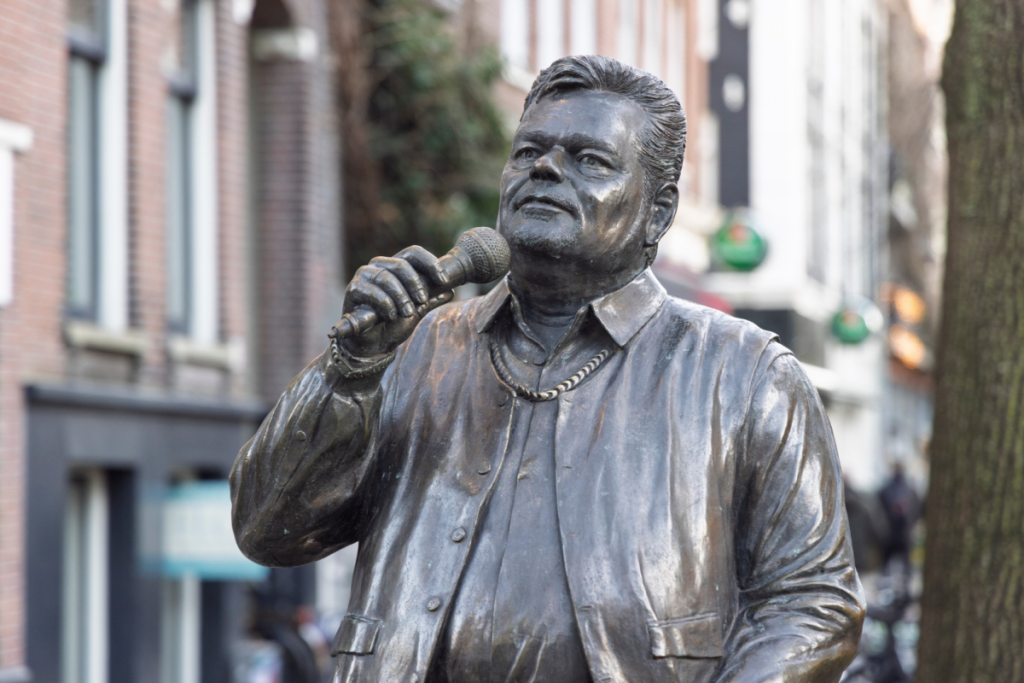 Die Bronzestatue des Sängers André Hazes mit einem Mikrofon auf dem Albert-Cuyp-Markt in Amsterdam.