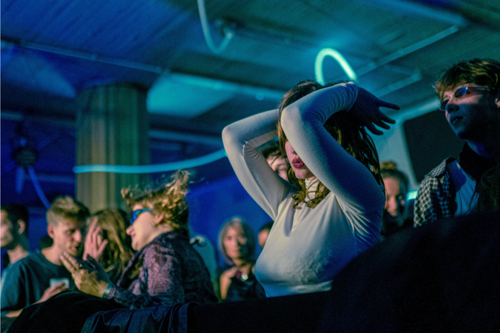 Dancing crowd in blue neon light during a club night at Listen Festival in Brussels