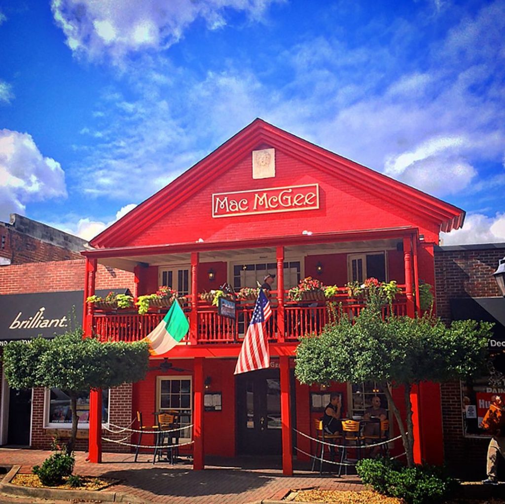 red two story pub with a blue sky behind it