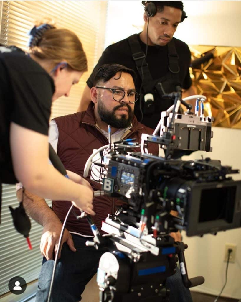 Photo of a camera man filming a scene