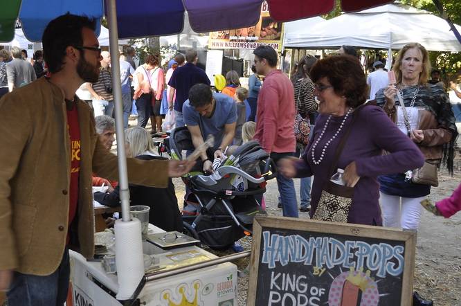 vendors set up at an outdoor arts market