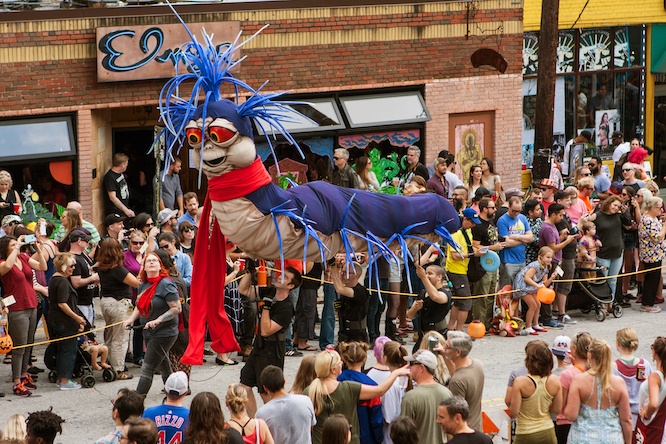 ATLANTA, GA - OCTOBER 15: Puppeteers carry a giant caterpillar puppet along the parade route of the annual Little Five Points Halloween parade, on October 15, 2016 in Atlanta, GA.