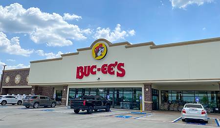 Warner Robins, Georgia - 2023: Buc-ee's convenience store and gas station. Exterior of store with beaver logo, yellow circle and black outline. Texas based chain is growing in US south east.