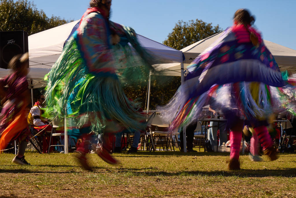 Native women in a traditional outfit, dancing
