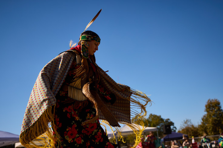 Native woman in a traditional outfit, dancing