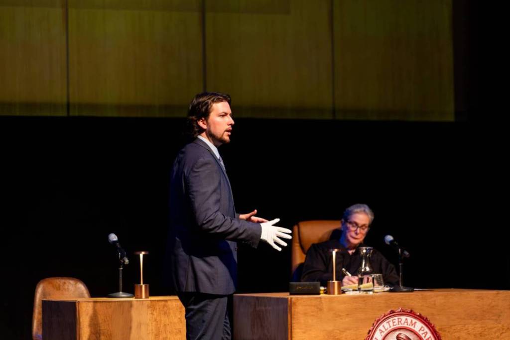 A lawyer addressing the jury as the judge listens