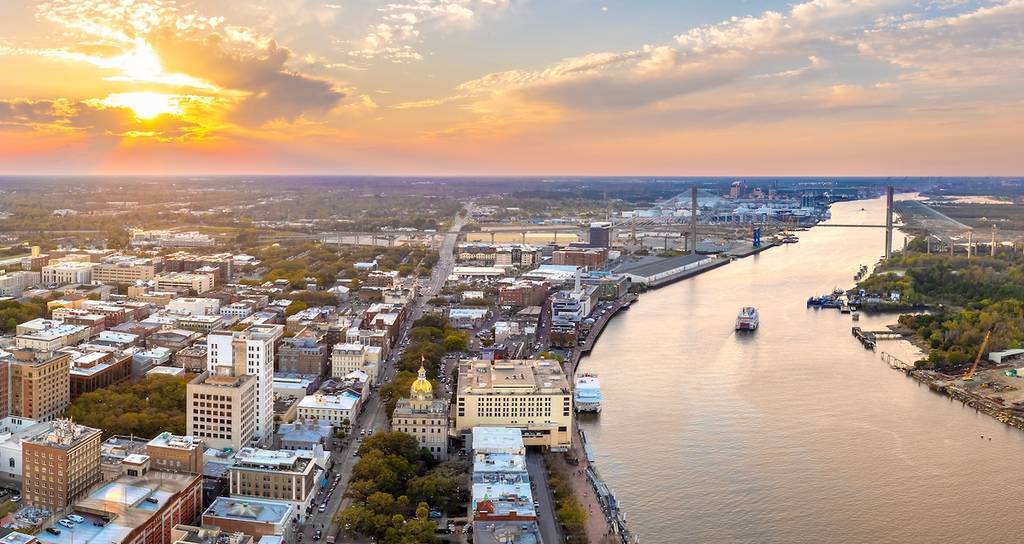 Savannah, Georgia. Famous historic River Street with waterfront tourist attractions. USA cityscape at sunset