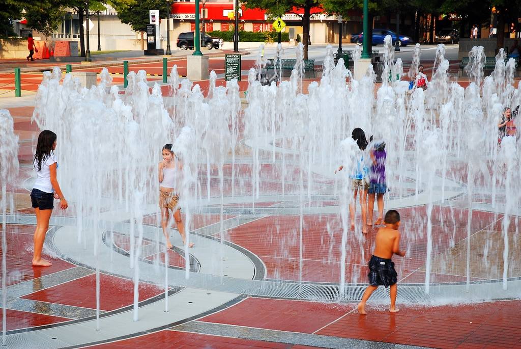 Atlanta, GA USA September 20 Families enjoy cooling down in the water fountains, shaped lie Olympic Rings in Centennial Park in Atlanta