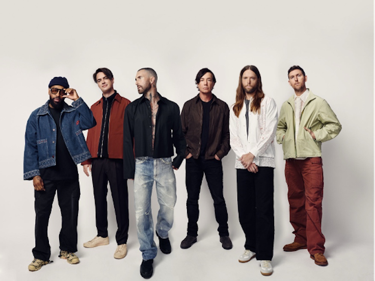 members of Maroon 5 standing next to each other in a line