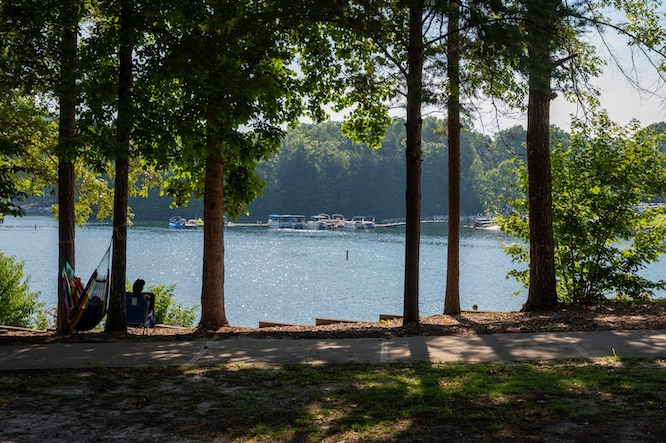 Salem, South Carolina, United States, 2 July 2019: At the serene shores of Lake Jocassee in South Carolina, a woman enjoys blissful relaxation in a hammock nestled among trees.