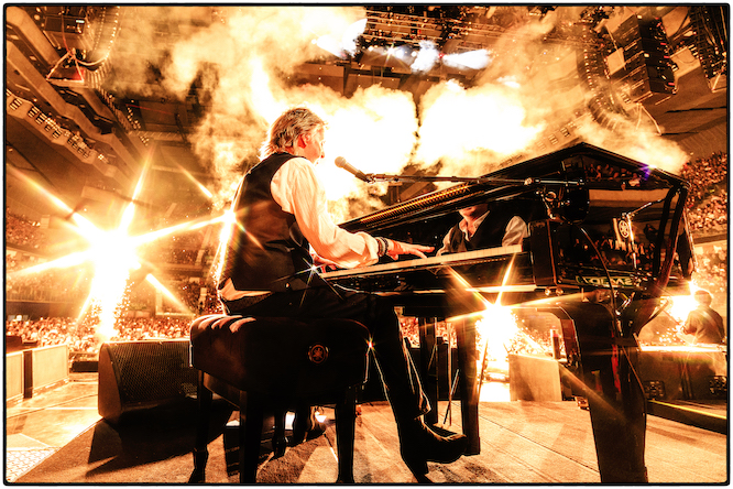Paul McCartney at a piano on stage
