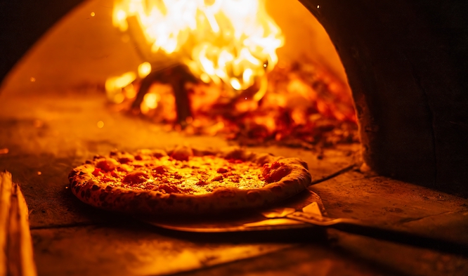 Pizza on a peel in the oven