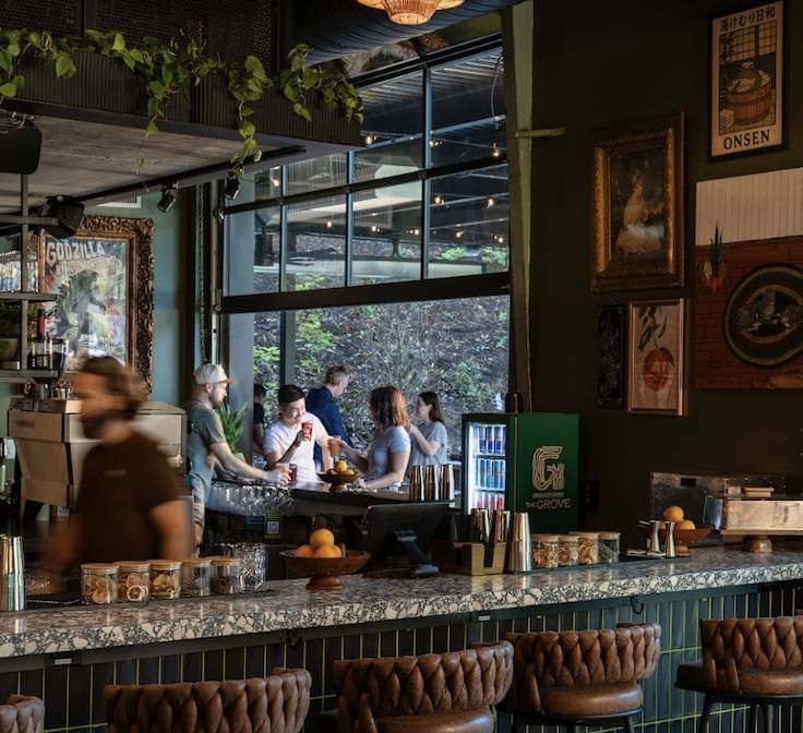 people at a dark and sexy bar with an open garage door