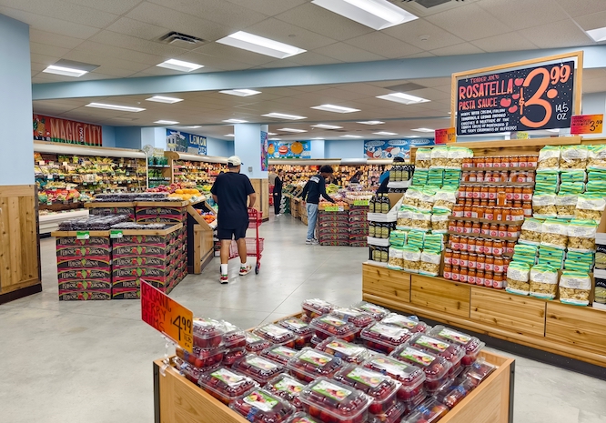 Miami, Florida - July 9, 2024: Customers shop for groceries at Trader Joe's. The store features fresh produce, packaged foods, and other grocery items.