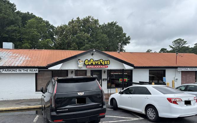 restaurant with a 'gut busters' sign