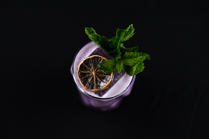 fancy purple cocktail with mint sprig