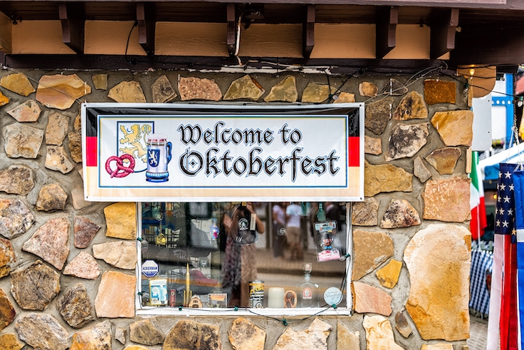 Helen, USA - October 5, 2021: Bavarian village of Helen, Georgia with The Heidelberg restaurant entrance by welcome sign for famous Oktoberfest festival in fall season