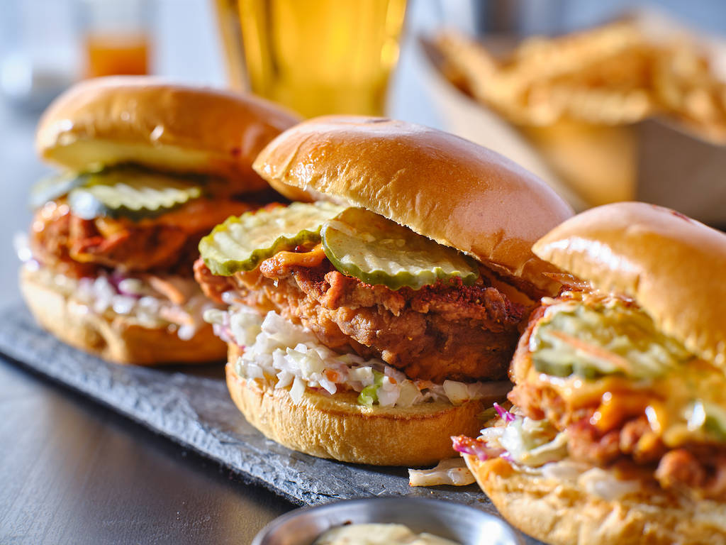 spicy nashville hot chicken sandwich with coleslaw and pickles