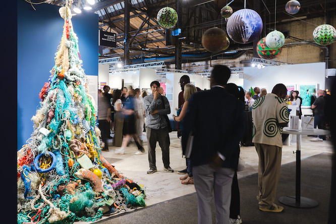 people walking around at an art gallery