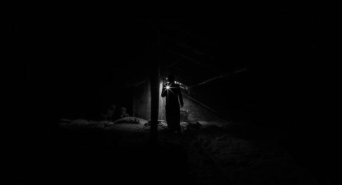 man in the dark with a flashlight