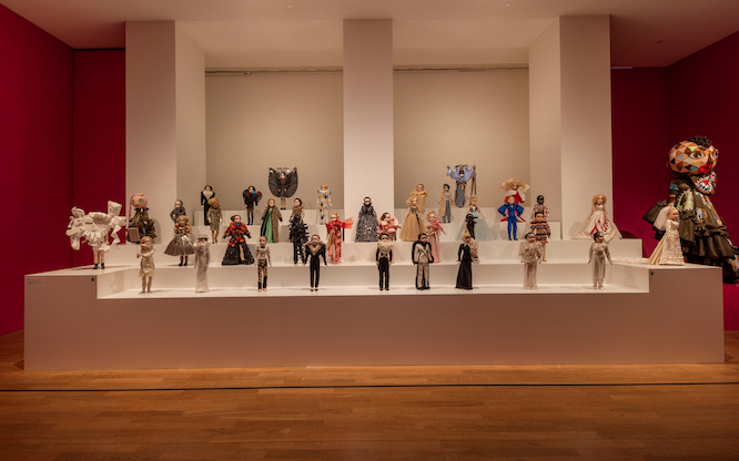 tons of high fashion outfits on small mannequins