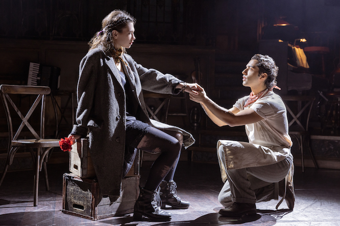 man on one knee in front of a woman in a suit