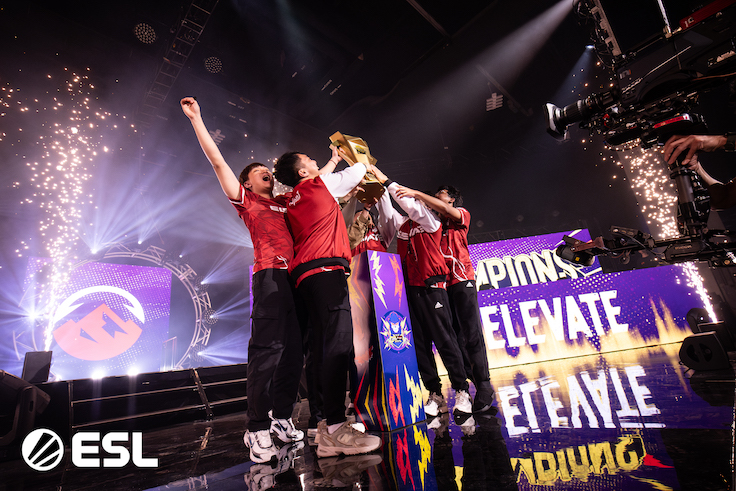 a team cheering their video game win on stage