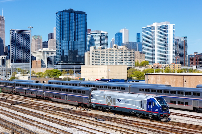 Chicago, United States - May 3, 2023: Skyline with Amtrak Midwest passenger train railway near Union Station in Chicago, United States.