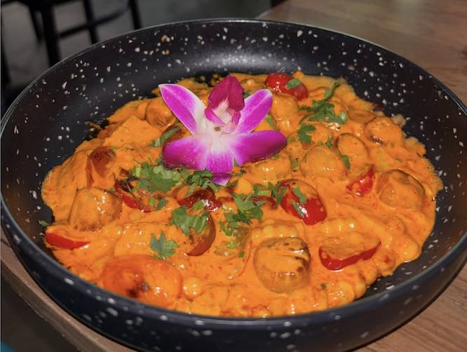 a Mexican food dish with a big pink flower in it
