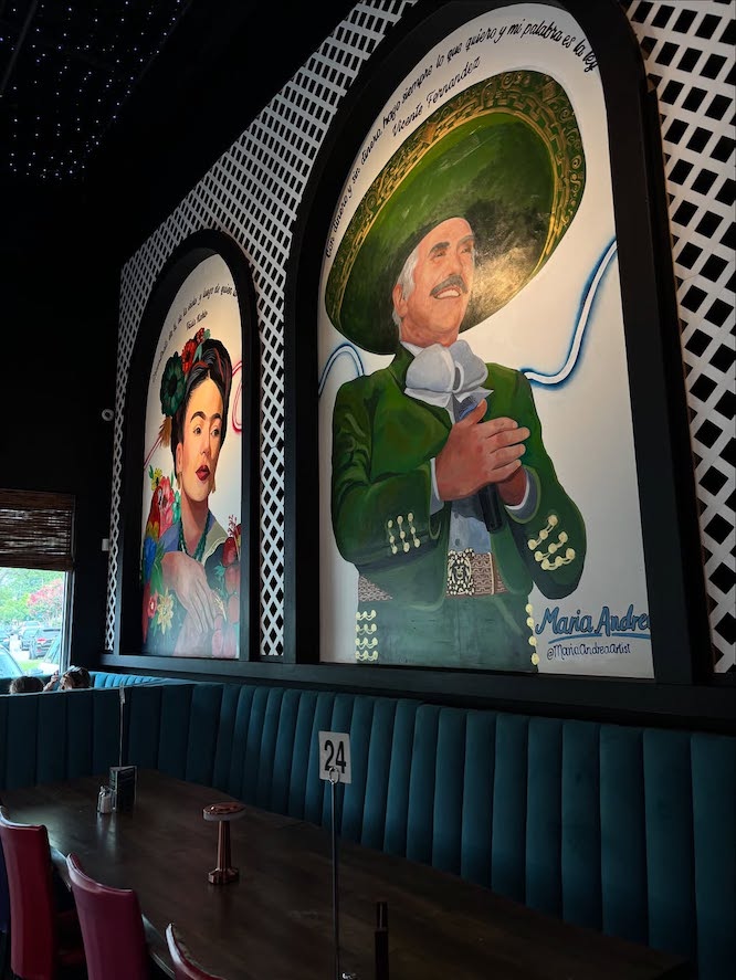 beautiful murals of Frida Kahlo and a man in traditional Mexican wear