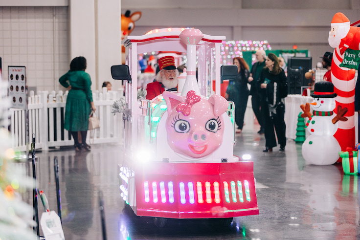 Pink piggy train being driven by Santa claus