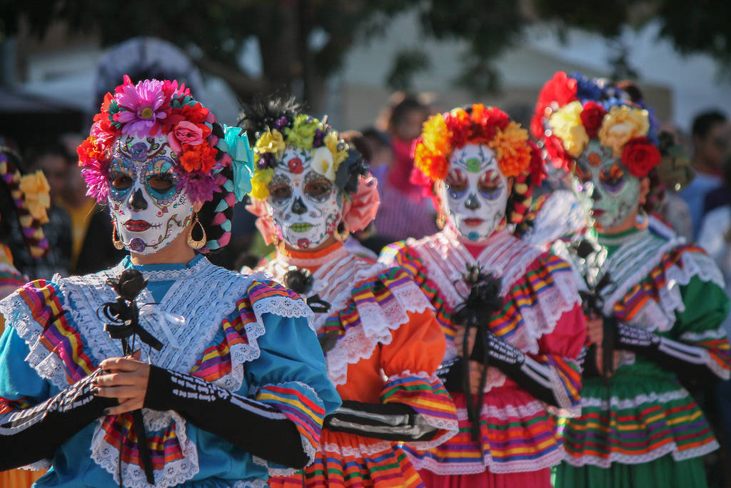 Colorful women with a skull mask during day of the dead
