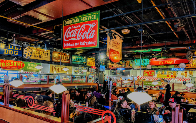 Bolingbrook, Illinois, USA - April 8, 2018: Customers enjoy their Sunday lunch inside of a suburban Chicago Portillo's location. Portillo's is famous for serving Chicago style hot dogs.