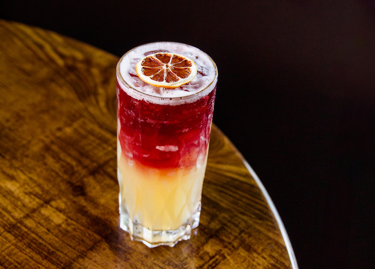 fancy cocktail with red and orange