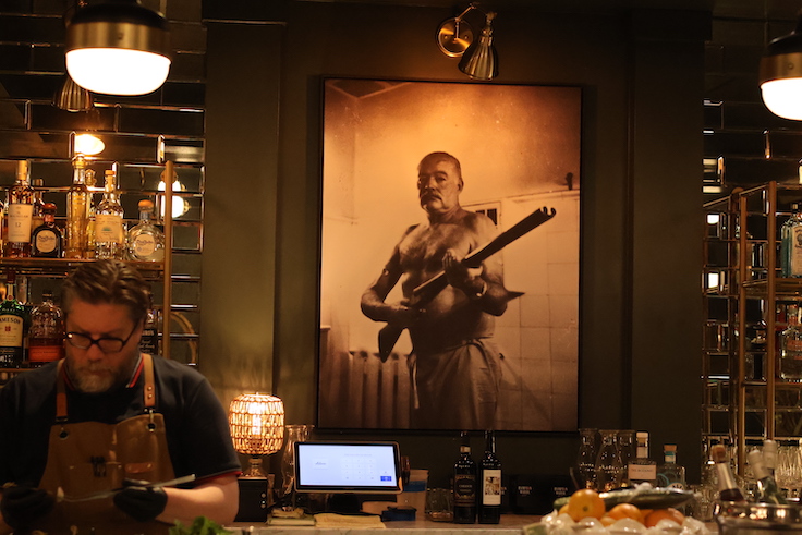 portrait of Hemingway holding a gun