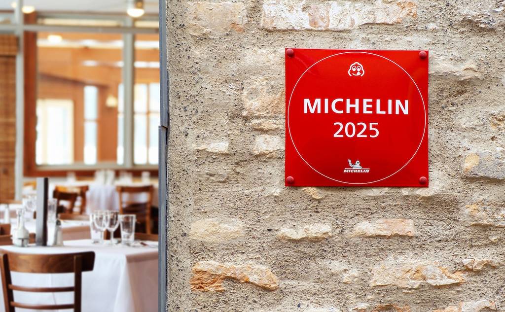 VILNIUS, LITHUANIA - JANUARY 30, 2025: Michelin Guide star sign for restaurant excellence hanging on brick wall