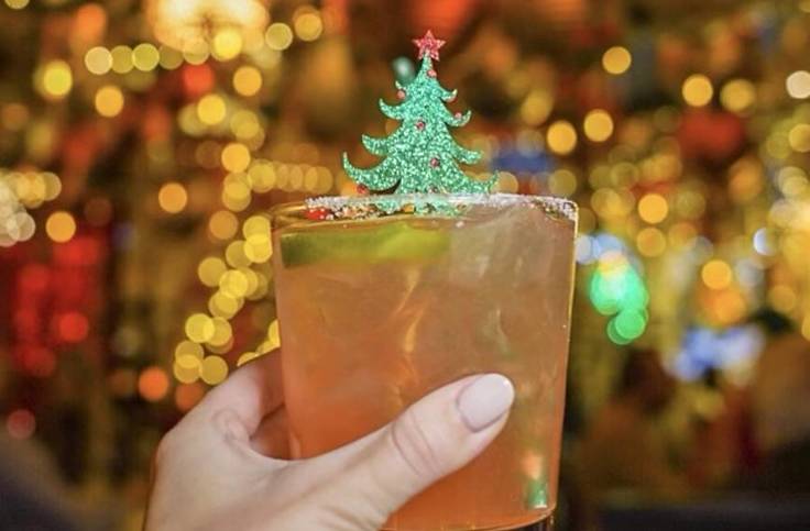 a fancy cocktail with a Christmas tree on it
