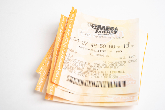 Vidalia, Georgia / USA - September 27, 2019: A macro shot of a single stack of Georgia Lottery’s Mega Millions with Megaplier tickets on plain white background.