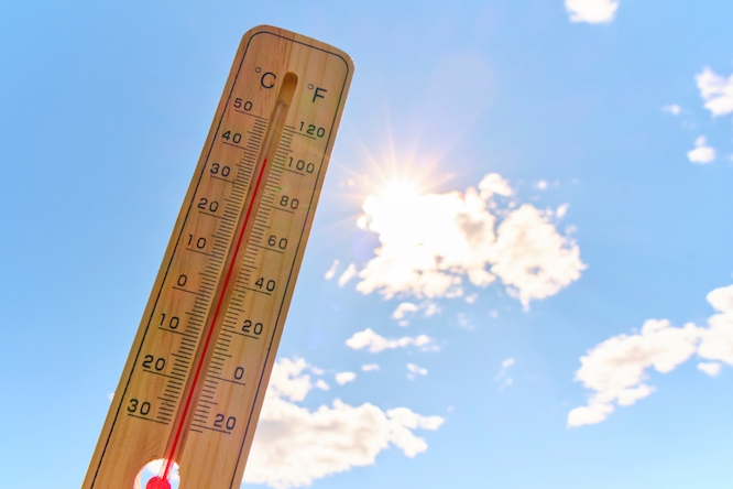 Wooden outdoor thermometer background scorching summer sun and blue sky