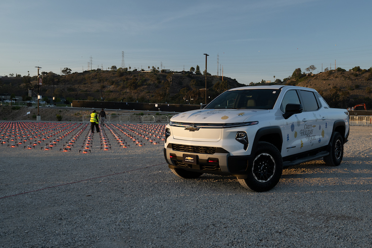a ton of drones on the ground behind a truck