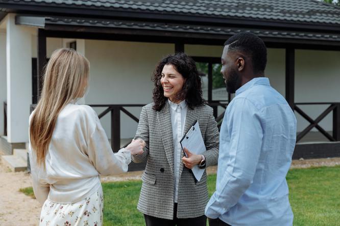 a realtor giving keys to an interracial couple