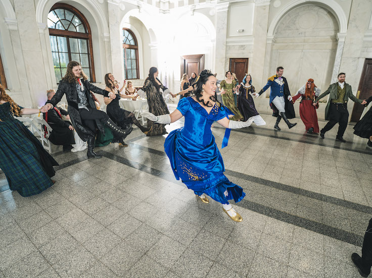 woman dancing in a bright blue renaissance dress