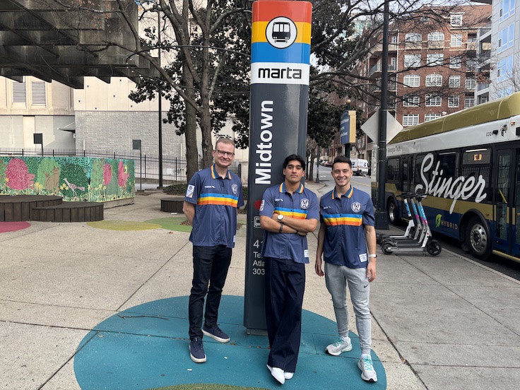 three men pose with a world record in front of the MARTA sign