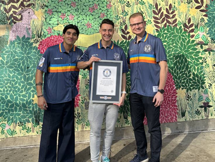 three men pose with a world record in front of the MARTA sign