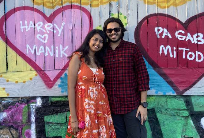 heart mural with a couple in front of it