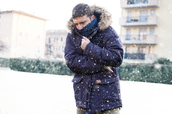 Portrait of man feeling very cold and shivering in winter