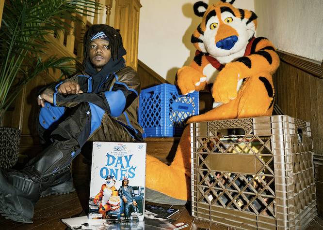 JID and Tony the Tiger sitting on a wooden staircase