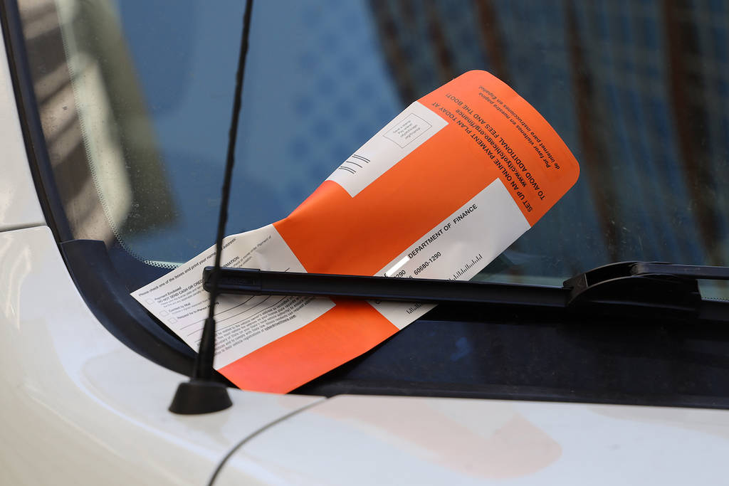 CHICAGO, ILLINOIS - MARCH 12, 2019: Illegal Parking Violation Citation On Car Windshield in Chicago